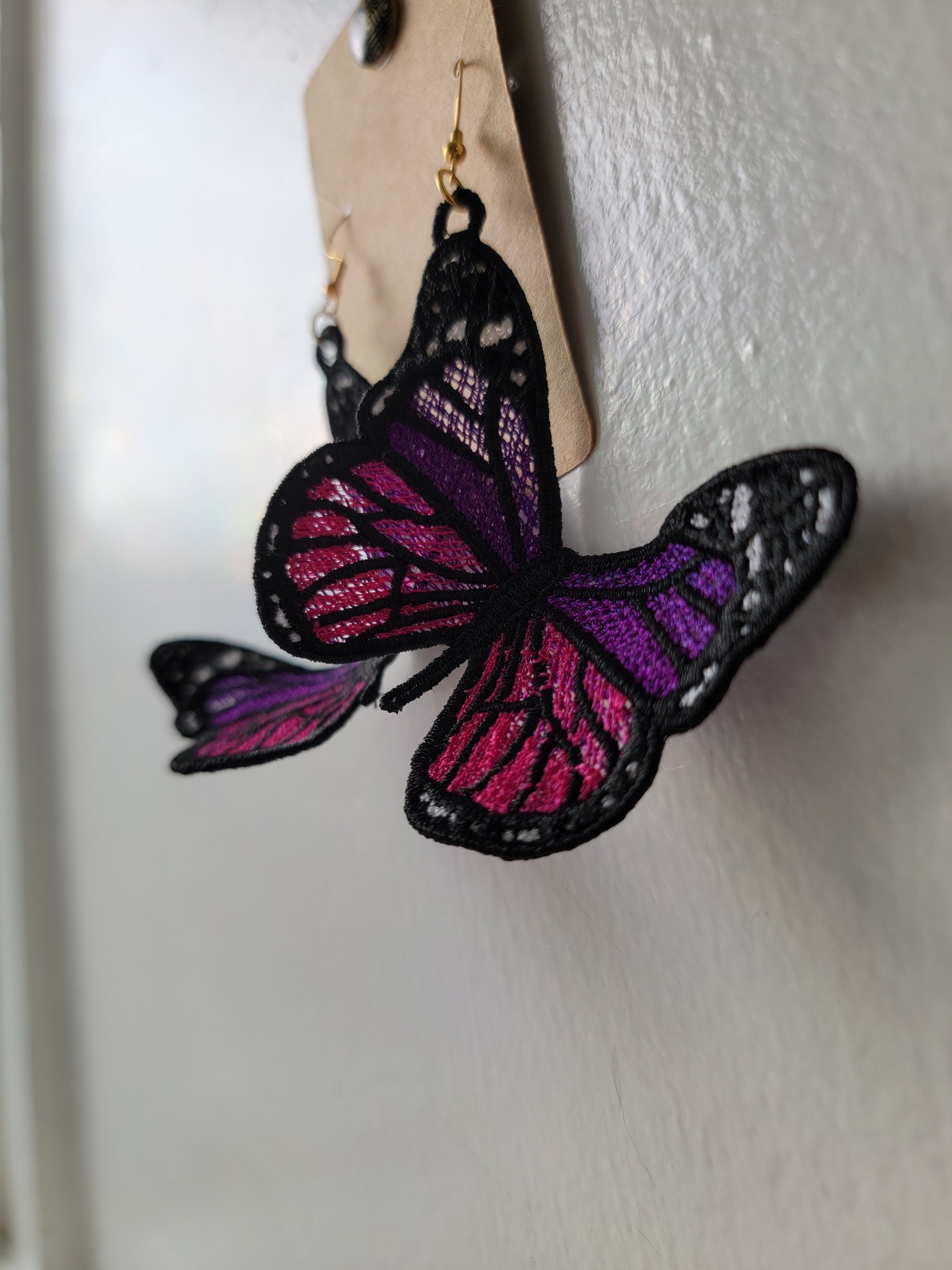 Earring card, PVC plastic, opaque black and purple, 2x1-1/2 inch square  with butterfly design. Sold per pkg of 100. - Fire Mountain Gems and Beads